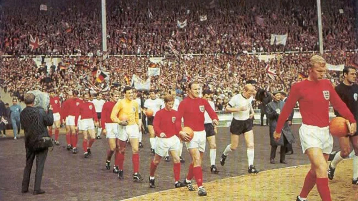 The 1966 FIFA World Cup Final — England (in red) and Germany entering to the Wembley field to play the WC final. Leading the English team, captain Bobby Mo