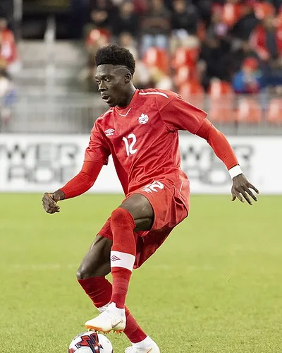 Alphonso Davies — Alphonso Davies playing for Canada in a match against Dominica on 16 October 2018.